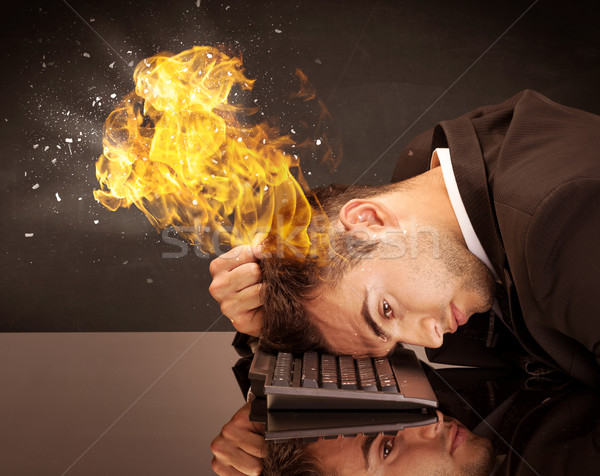 Stressed business man's head is burning Stock photo © ra2studio