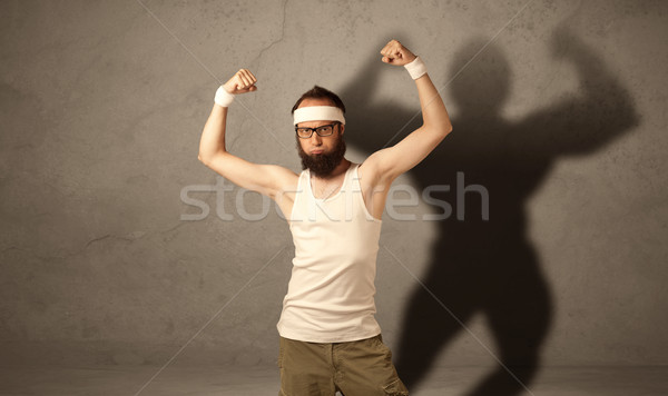 Skinny man with musculous shadow Stock photo © ra2studio