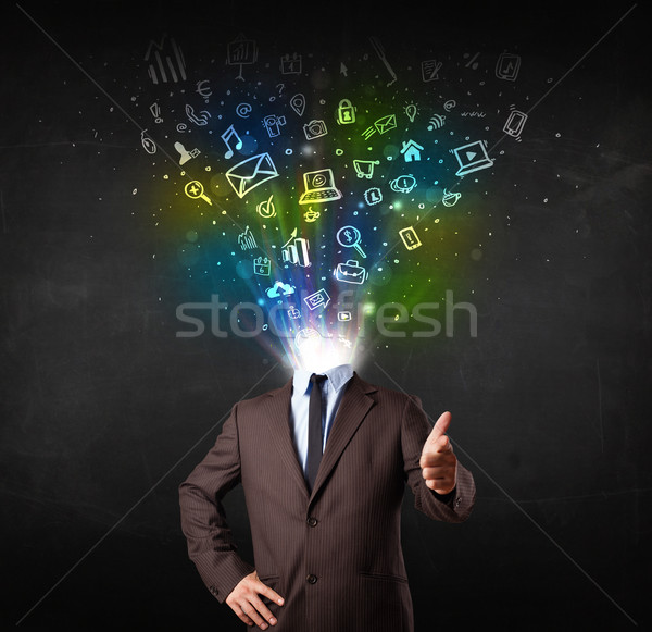 Business man with glowing media icons exploding head  Stock photo © ra2studio