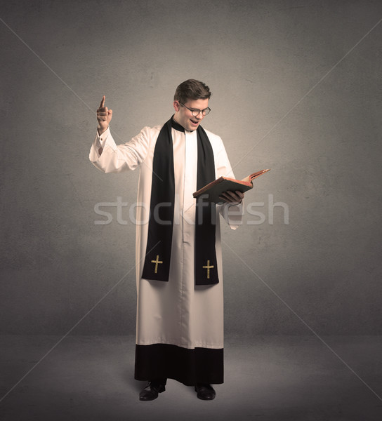 Prêtre bénédiction jeunes main livre lumière [[stock_photo]] © ra2studio