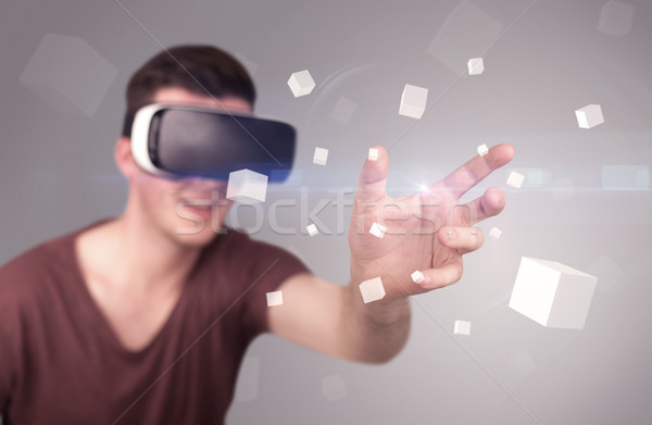 Man wearing virtual reality goggles Stock photo © ra2studio