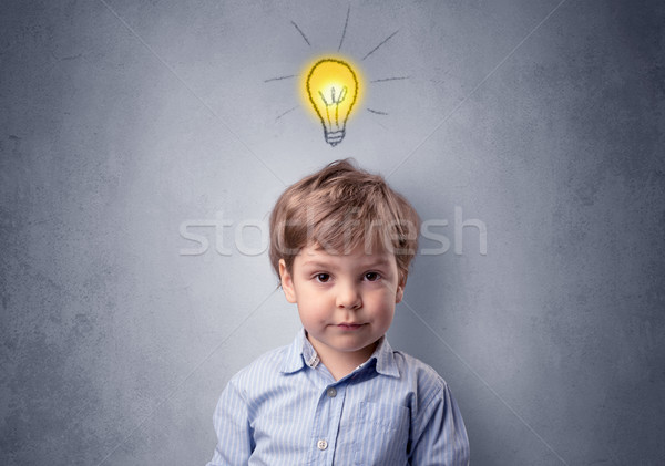 Little boy mull over with bulb above his head Stock photo © ra2studio
