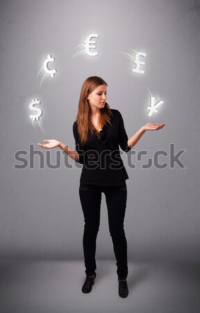  young lady standing and juggling with currency icons Stock photo © ra2studio