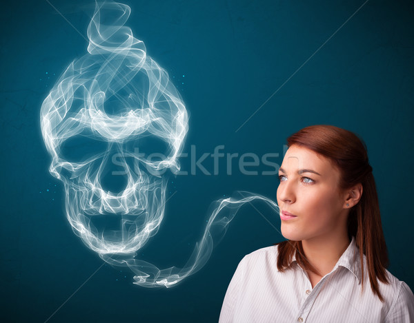 Genç kadın sigara içme tehlikeli sigara toksik kafatası Stok fotoğraf © ra2studio