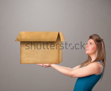 Young woman holding an empty cardboard box Stock photo © ra2studio