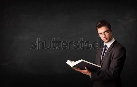 Young man reading a book Stock photo © ra2studio