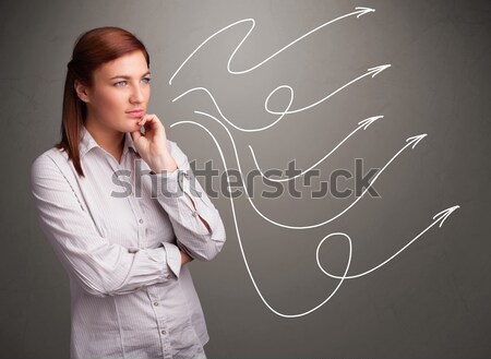 Attractive teenager looking at multiple curly arrows Stock photo © ra2studio