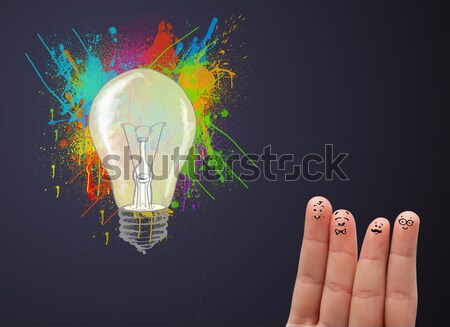 Happy cheerful smiley fingers looking at abstract hand drawn colorful lightbulb Stock photo © ra2studio