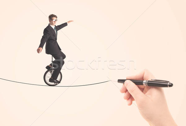 Businessman riding monocycle on a rope drawn by hand Stock photo © ra2studio