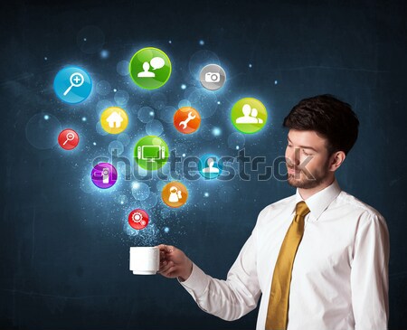 Businessman holding a white cup with setting icons Stock photo © ra2studio
