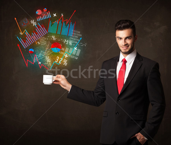 Businessman holding a white cup with diagrams and graphs Stock photo © ra2studio