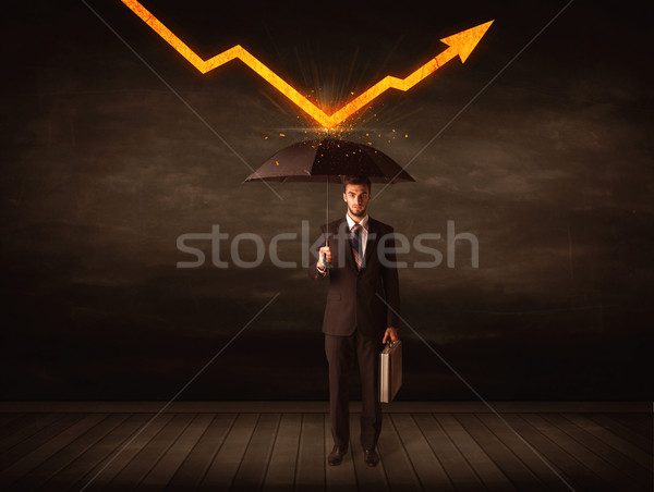 Businessman standing with umbrella keeping orange arrow  Stock photo © ra2studio
