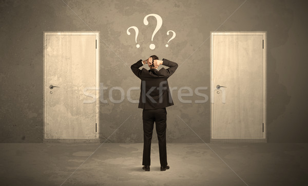 Businessman standing in front of doors Stock photo © ra2studio