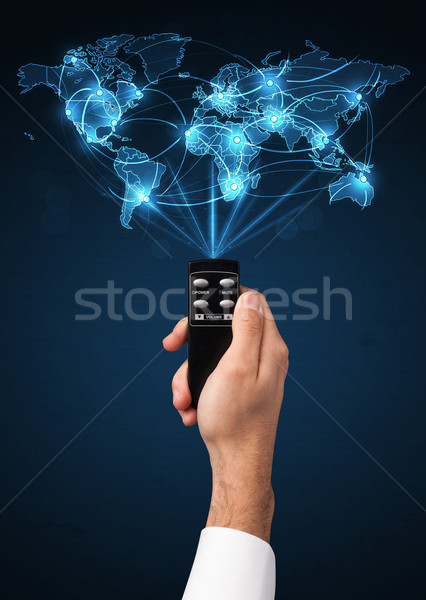 Hand with remote control, social media concept Stock photo © ra2studio