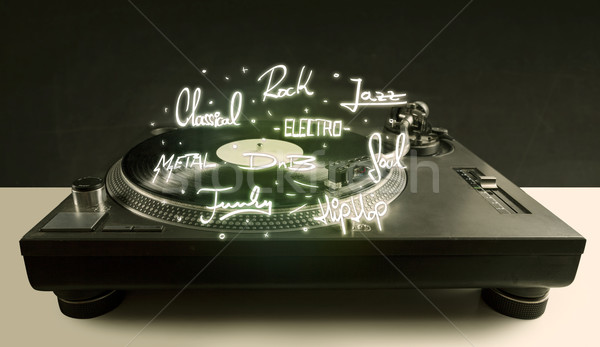 Stock photo: Turntable with vinyl and music genres writen 