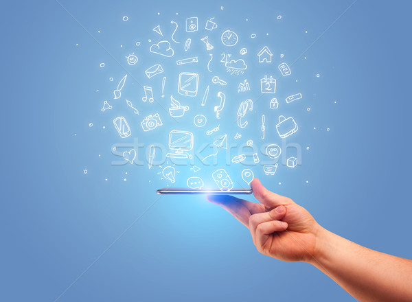 Hand with phone and drawn office icons Stock photo © ra2studio