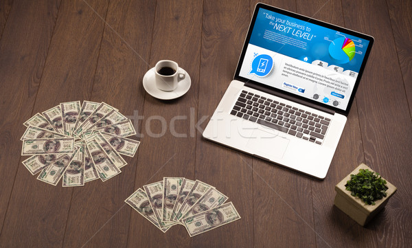 Laptop on office desk with business website on screen Stock photo © ra2studio