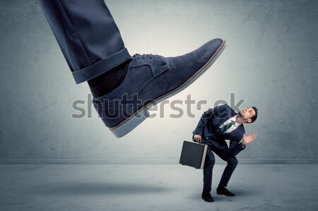Employee getting trampled by big shoe Stock photo © ra2studio