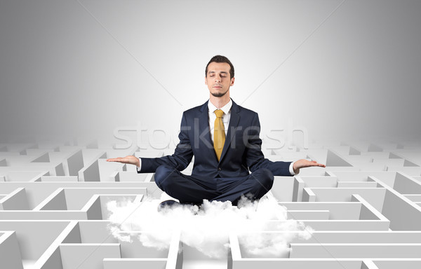 Businessman meditates on a cloud with maze concept Stock photo © ra2studio