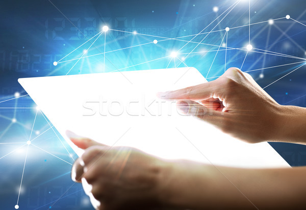 Hands touching a glass-like tablet  Stock photo © ra2studio