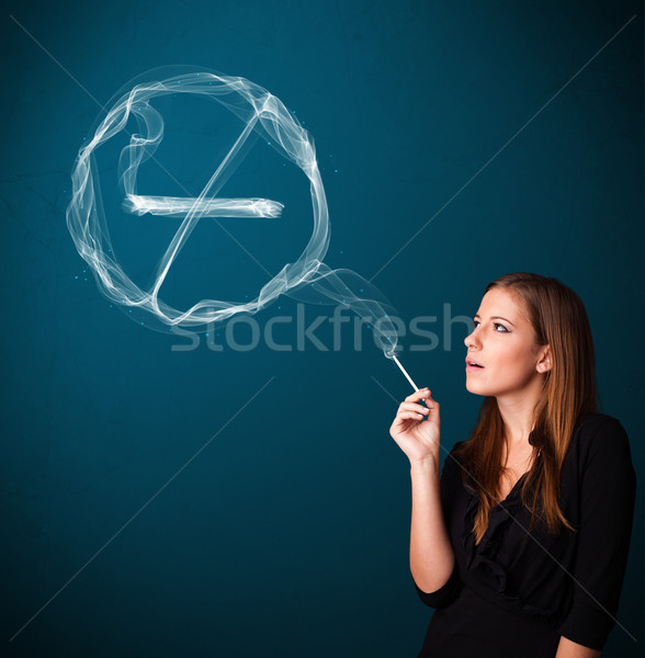 Young lady smoking unhealthy cigarette with no smoking sign Stock photo © ra2studio