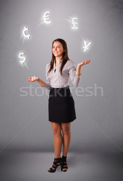  young lady standing and juggling with currency icons Stock photo © ra2studio