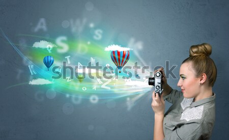 Stock photo: Worker with airbrush and colorful abstract clouds and balloons