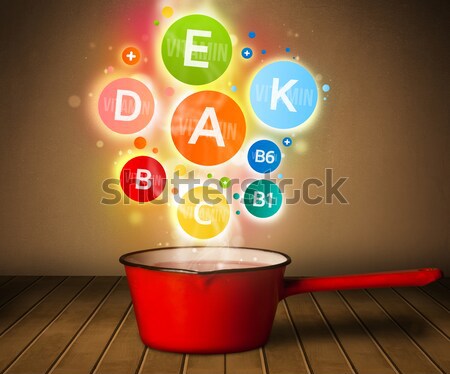 Stock photo: Colorful vitamins coming out from cooking pot