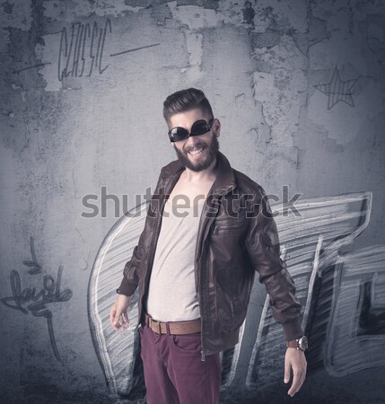 Stock photo: Fashion model standing at graffiti wall