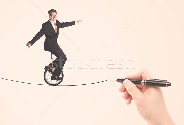 Businessman riding monocycle on a rope drawn by hand Stock photo © ra2studio