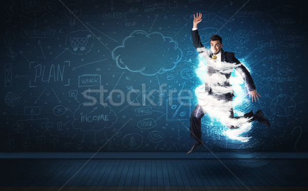 Happy business man jumping with storm cloud around him  Stock photo © ra2studio