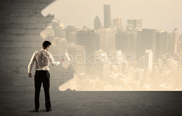 Salesman painting city scape on wall Stock photo © ra2studio