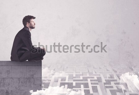 Sitting salesman on rooftop solving maze Stock photo © ra2studio