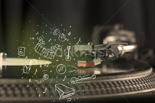 Stock photo: Turntable playing classical music with icon drawn instruments 