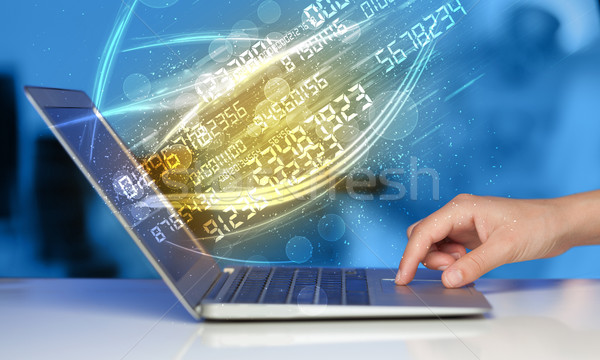 Stock photo: Man typing on modern notebook with number technology data coming