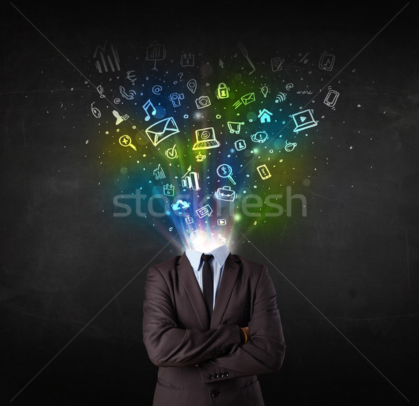 Business man with glowing media icons exploding head  Stock photo © ra2studio