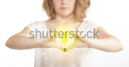 Hands creating a form with light bulb Stock photo © ra2studio