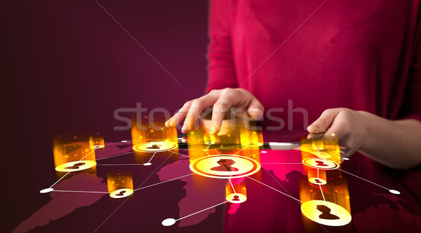 Hand holding tablet device with social network map Stock photo © ra2studio