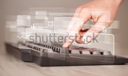 Hand touching keyboard with high tech buttons Stock photo © ra2studio