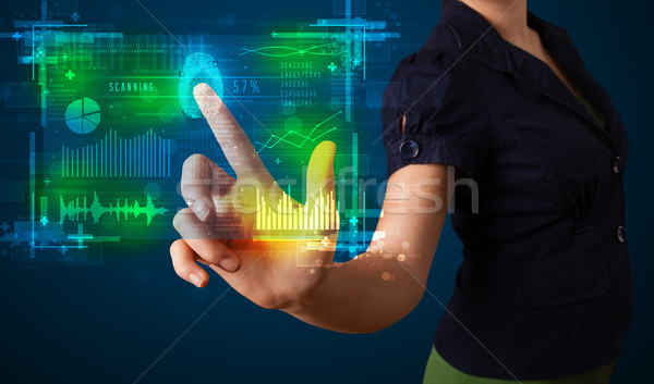 Young businesswoman pressing modern technology panel with finger Stock photo © ra2studio