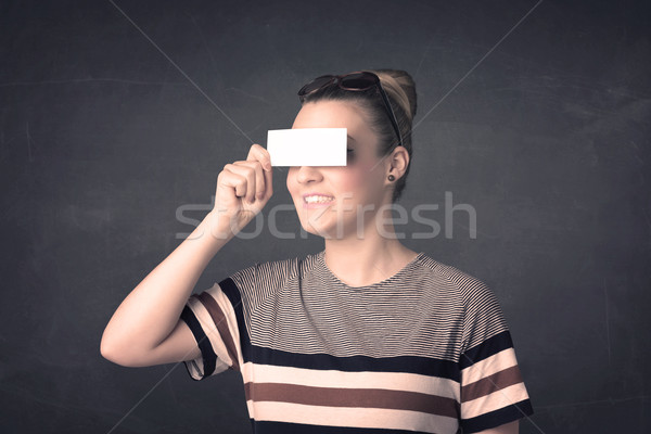 Pretty girl holding blank copy space paper at her eyes  Stock photo © ra2studio