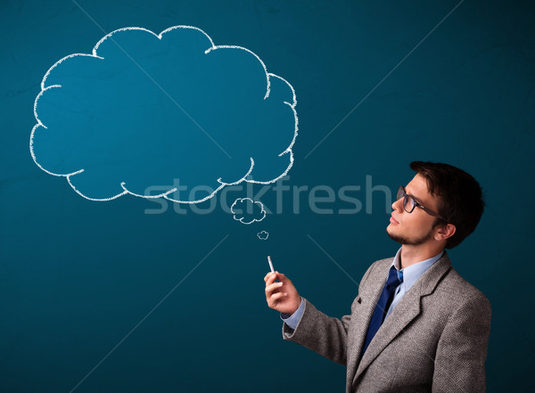 Stock photo: Young man smoking cigarette with idea cloud