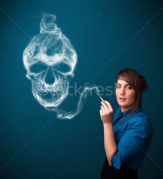 Młoda kobieta palenia niebezpieczny papierosów toksyczny czaszki Zdjęcia stock © ra2studio