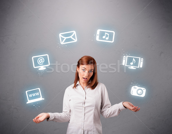 pretty girl juggling with elecrtonic devices icons Stock photo © ra2studio