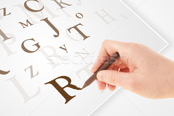 Hand writing various letters on white plain paper Stock photo © ra2studio