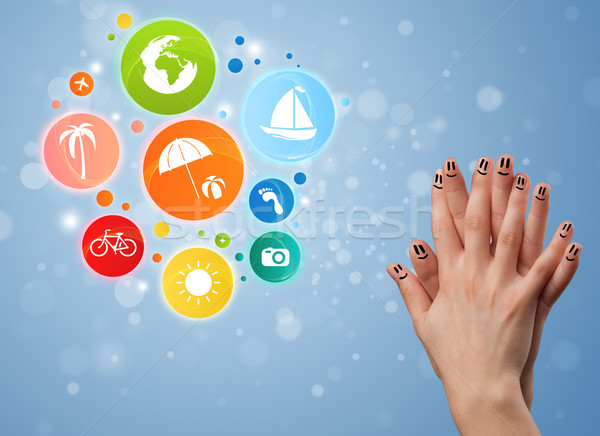 Cheerful happy smiling fingers with colorful holiday travel bubble icons Stock photo © ra2studio