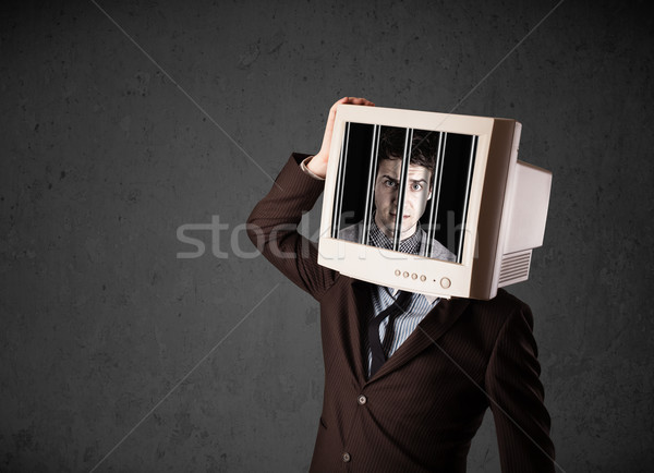 Stock photo: Business man with monitor on his head traped into a digital syst