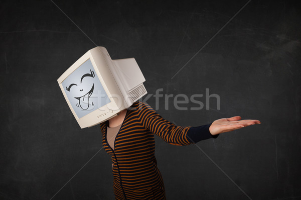 Stock photo: Young girl wearing a monitor with a funny face