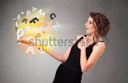 Young lady hoolding notebook with colorful abstract letters Stock photo © ra2studio