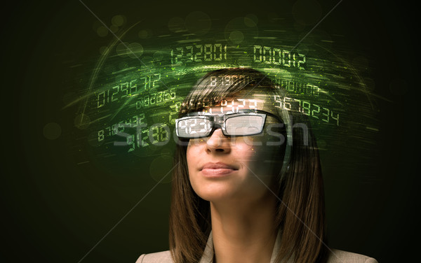 Business woman looking at high tech number calculations  Stock photo © ra2studio